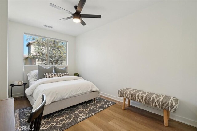 80218 Whisper Rock Way, La Quinta, CA 92253 - bedroom with baseboards, wood finished floors, and a ceiling fan