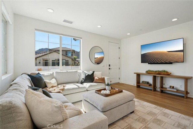 80218 Whisper Rock Way, La Quinta, CA 92253 - living room featuring light wood finished floors, recessed lighting, and baseboards