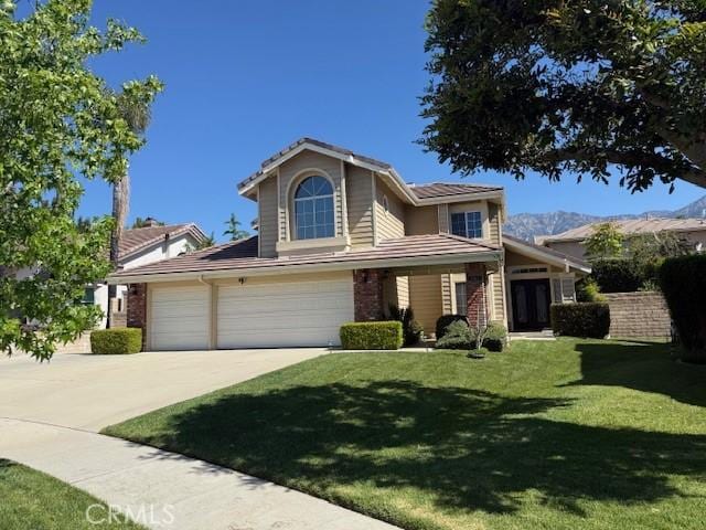 traditional-style house featuring driveway, a front yard, and an attached garage