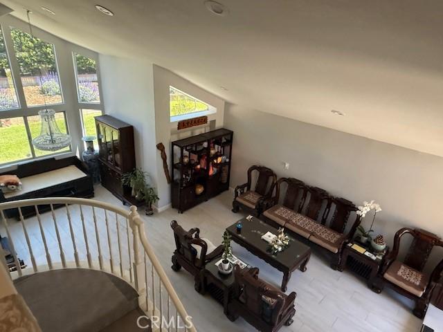 living room featuring lofted ceiling