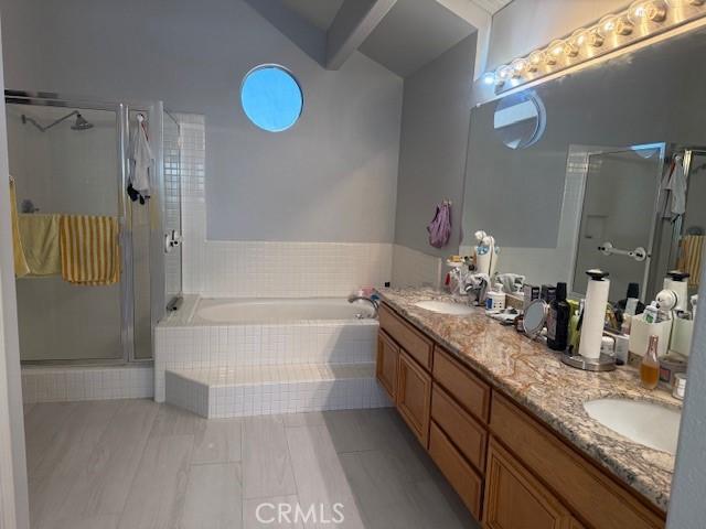 full bathroom featuring a garden tub, a shower stall, double vanity, and tile patterned flooring