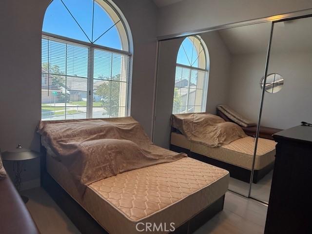 bedroom featuring multiple windows and a closet
