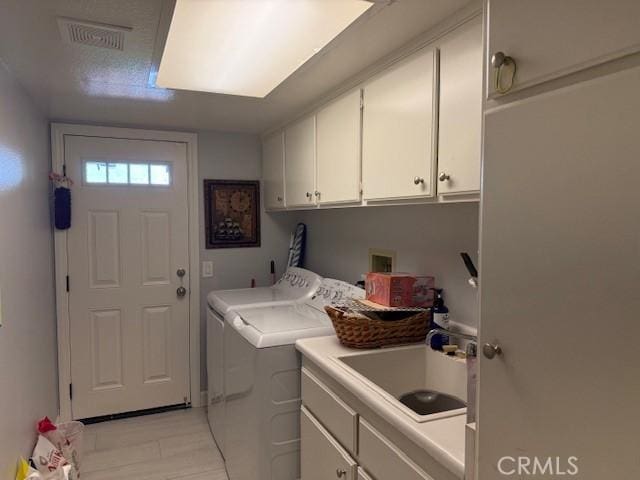 laundry room featuring cabinet space and washing machine and dryer