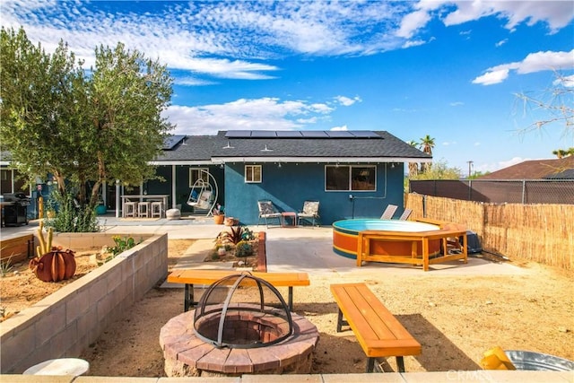 61475 Alta Vista Dr, Joshua Tree, CA 92252 - back of house featuring a fire pit, a patio area, solar panels, and a hot tub