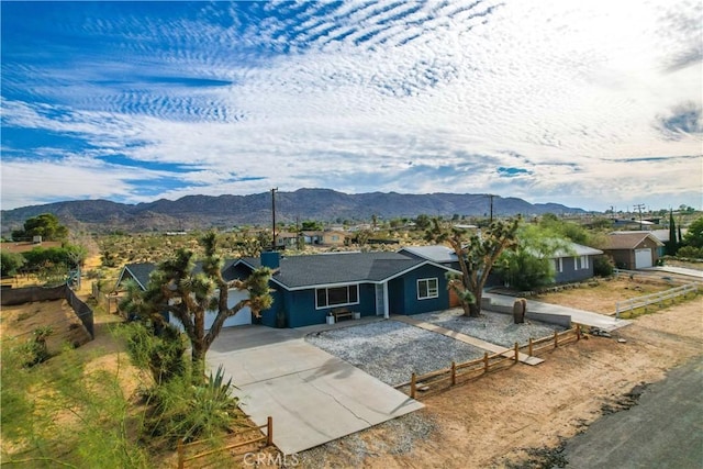 61475 Alta Vista Dr, Joshua Tree, CA 92252 - ranch-style house with concrete driveway, fence, a mountain view, and an attached garage