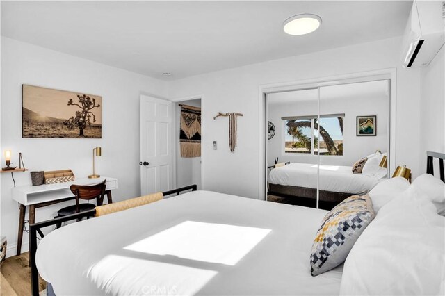 61475 Alta Vista Dr, Joshua Tree, CA 92252 - bedroom with a wall mounted air conditioner, light wood finished floors, and a closet