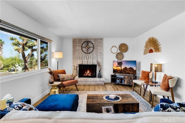 61475 Alta Vista Dr, Joshua Tree, CA 92252 - living area featuring wood finished floors, a brick fireplace, and baseboards