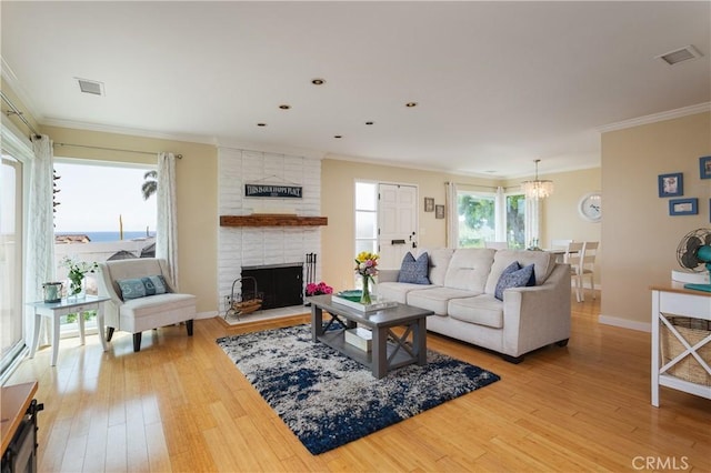 379 Camino, San Clemente, San Clemente, CA 92672 - living room featuring light wood finished floors, a chandelier, ornamental molding, a fireplace, and baseboards