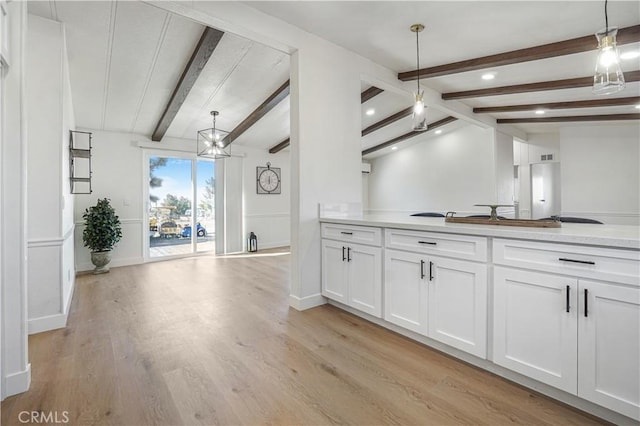 6294 Sunnyslope Rd, Phelan, CA 92371 - kitchen featuring light wood-style flooring, white cabinetry, light countertops, a chandelier, and decorative light fixtures