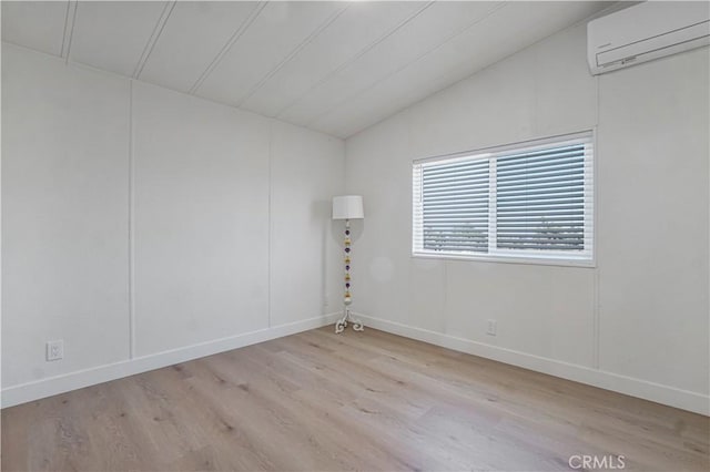 6294 Sunnyslope Rd, Phelan, CA 92371 - empty room featuring a wall mounted AC, lofted ceiling, wood finished floors, and baseboards