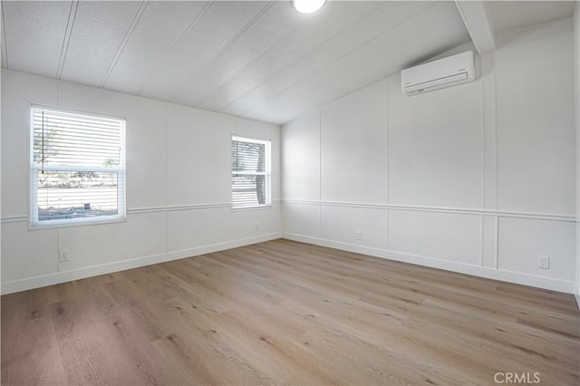 6294 Sunnyslope Rd, Phelan, CA 92371 - unfurnished room featuring a wall unit AC, light wood finished floors, a decorative wall, and vaulted ceiling