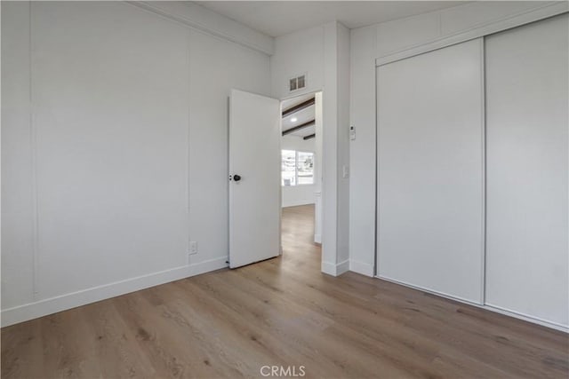 6294 Sunnyslope Rd, Phelan, CA 92371 - unfurnished bedroom with wood finished floors, baseboards, and a closet