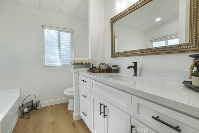 6294 Sunnyslope Rd, Phelan, CA 92371 - bathroom with toilet, vanity, wood finished floors, and healthy amount of natural light