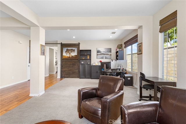 27335 Wedgewood Way, Murrieta, CA 92562 - carpeted living area featuring a barn door, baseboards, recessed lighting, and wood finished floors