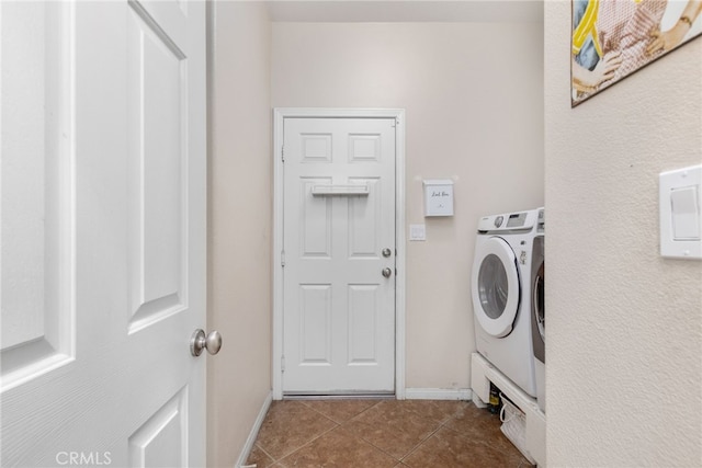 27335 Wedgewood Way, Murrieta, CA 92562 - laundry room with washing machine and clothes dryer, dark tile patterned floors, and baseboards