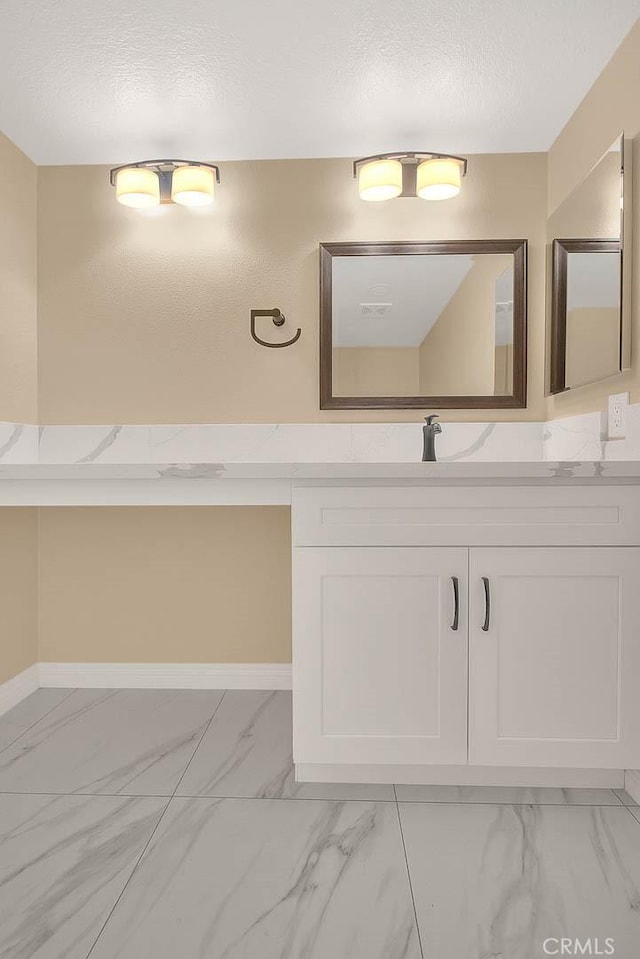 23020 Paseo De Terrado Unit 2, Diamond Bar, CA 91765 - bathroom featuring marble look tiles, vanity, a textured ceiling, and baseboards