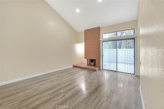 23020 Paseo De Terrado Unit 2, Diamond Bar, CA 91765 - unfurnished living room with high vaulted ceiling, wood finished floors, a fireplace, baseboards, and recessed lighting