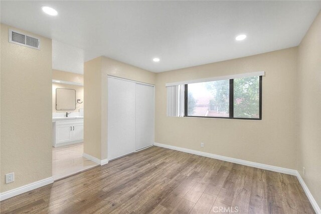 23020 Paseo De Terrado Unit 2, Diamond Bar, CA 91765 - unfurnished bedroom with wood finished floors, a closet, baseboards, recessed lighting, and ensuite bathroom