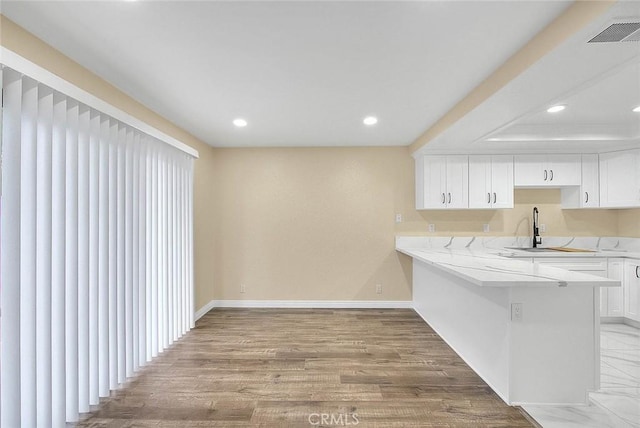 23020 Paseo De Terrado Unit 2, Diamond Bar, CA 91765 - kitchen featuring light countertops, recessed lighting, white cabinetry, baseboards, and wood finished floors