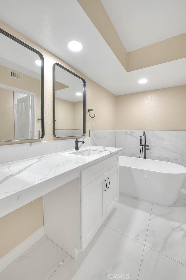 23020 Paseo De Terrado Unit 2, Diamond Bar, CA 91765 - bathroom with marble finish flooring, tile walls, a freestanding bath, recessed lighting, and vanity