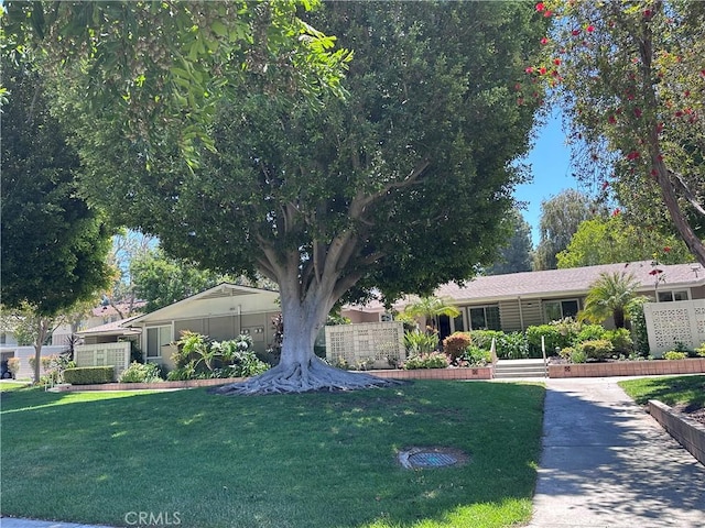 253 Calle Aragon Unit F, Laguna Woods, CA 92637 - view of front facade with a front yard