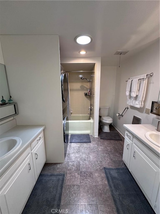 253 Calle Aragon Unit F, Laguna Woods, CA 92637 - full bathroom featuring stacked washer and clothes dryer, two vanities, toilet, and shower / tub combination