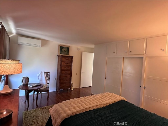 253 Calle Aragon Unit F, Laguna Woods, CA 92637 - bedroom with a wall mounted air conditioner, dark wood-style flooring, and a closet