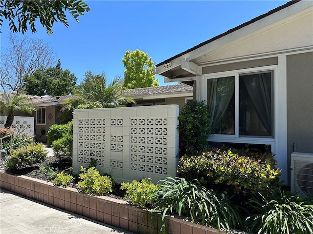 253 Calle Aragon Unit F, Laguna Woods, CA 92637 - exterior view of stucco siding, mail area, and ac unit