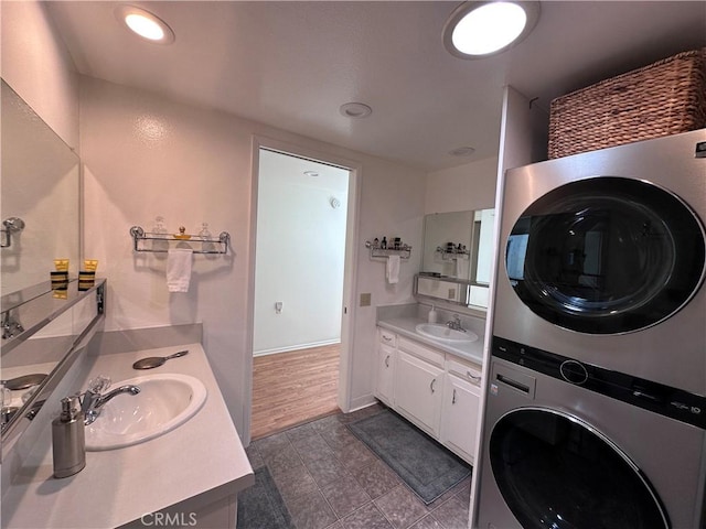 253 Calle Aragon Unit F, Laguna Woods, CA 92637 - laundry room with stacked washing machine and dryer and dark tile patterned floors
