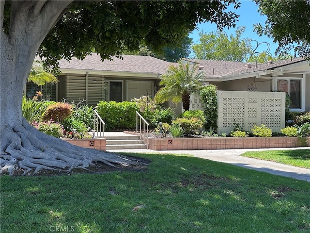 253 Calle Aragon Unit F, Laguna Woods, CA 92637 - back of house with a yard