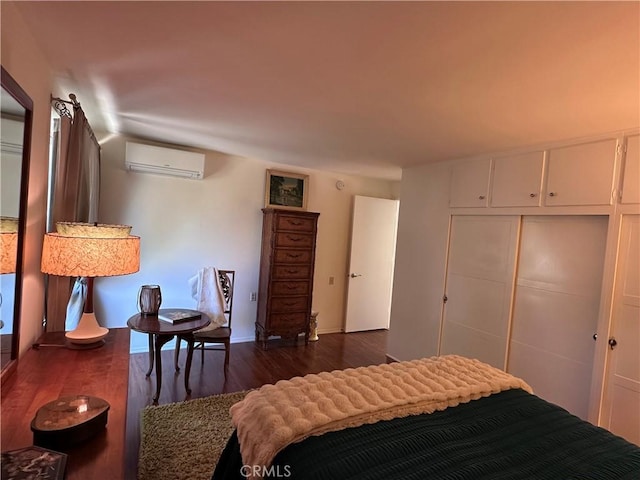 253 Calle Aragon Unit F, Laguna Woods, CA 92637 - bedroom featuring a wall mounted AC, dark wood-style floors, a closet, and baseboards