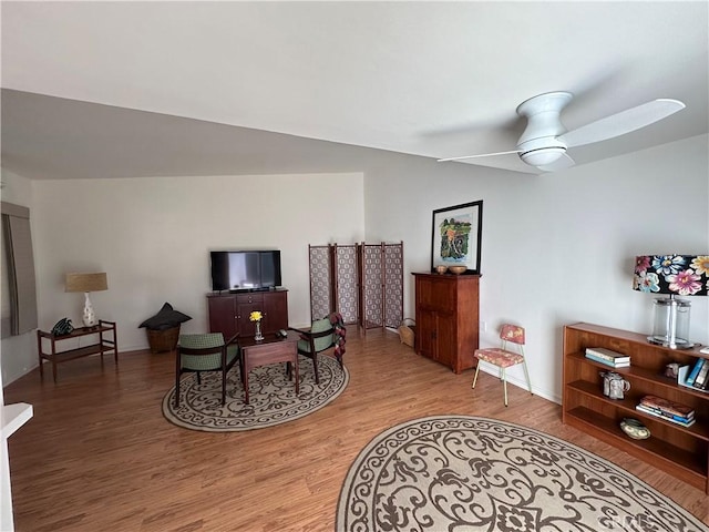 253 Calle Aragon Unit F, Laguna Woods, CA 92637 - sitting room with light wood-style floors, ceiling fan, and baseboards