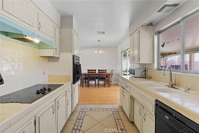 281 Harruby Dr, Calimesa, CA 92320 - kitchen featuring black appliances, tile counters, a sink, a chandelier, and under cabinet range hood