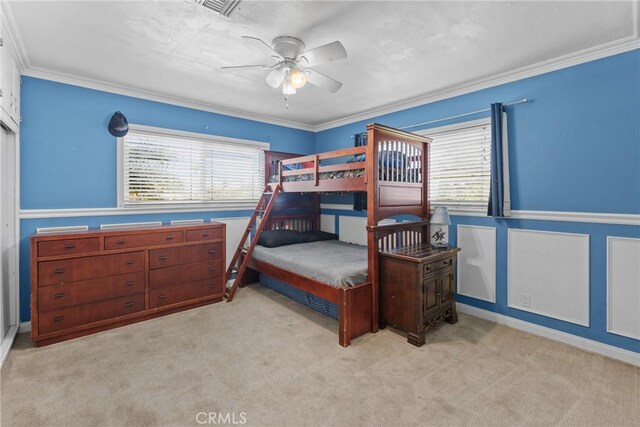 281 Harruby Dr, Calimesa, CA 92320 - bedroom with light carpet, wainscoting, crown molding, ceiling fan, and a decorative wall