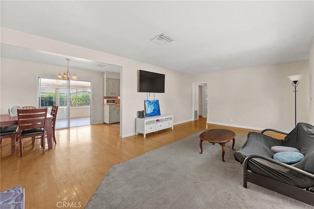 281 Harruby Dr, Calimesa, CA 92320 - living room with a chandelier, light wood finished floors, and baseboards