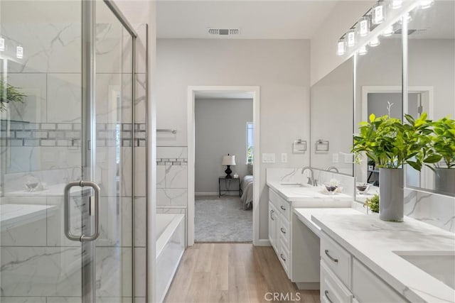 5122 Feather Rock Ct, Paradise, CA 95969 - ensuite bathroom featuring double vanity, a bath, wood finished floors, and a marble finish shower