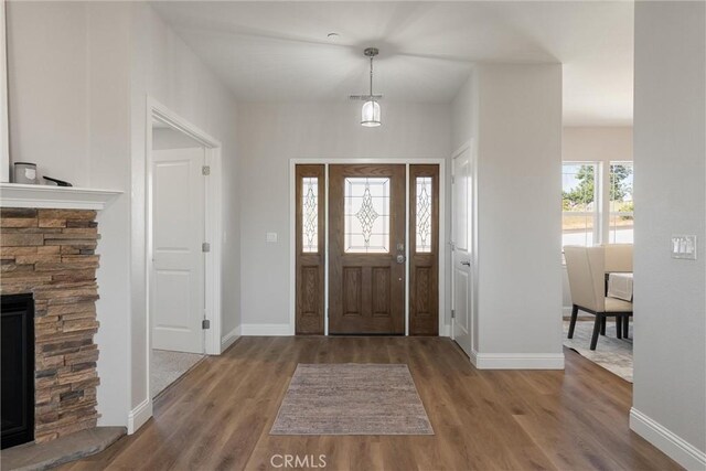 5122 Feather Rock Ct, Paradise, CA 95969 - entryway featuring wood finished floors, a fireplace, and baseboards