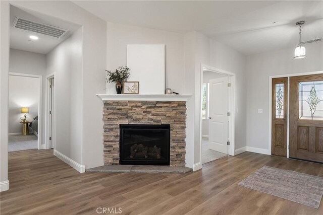 5122 Feather Rock Ct, Paradise, CA 95969 - foyer entrance featuring wood finished floors, baseboards, and a stone fireplace