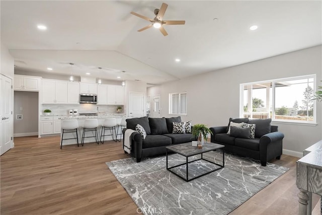 5122 Feather Rock Ct, Paradise, CA 95969 - living room with a ceiling fan, vaulted ceiling, recessed lighting, light wood-style floors, and baseboards