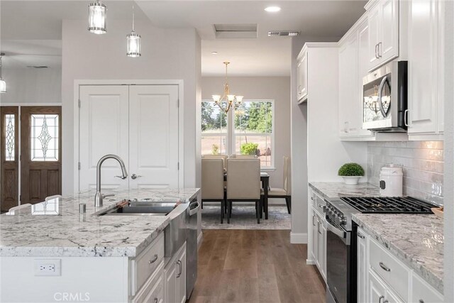 5122 Feather Rock Ct, Paradise, CA 95969 - kitchen with appliances with stainless steel finishes, a sink, white cabinets, and tasteful backsplash