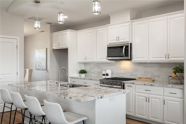 5122 Feather Rock Ct, Paradise, CA 95969 - kitchen with stainless steel appliances, tasteful backsplash, and white cabinets