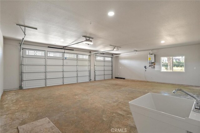 5122 Feather Rock Ct, Paradise, CA 95969 - garage with a sink, a garage door opener, recessed lighting, and water heater
