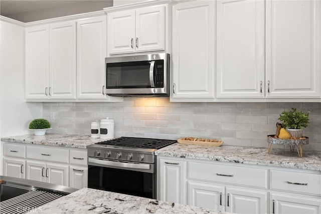 5122 Feather Rock Ct, Paradise, CA 95969 - kitchen with appliances with stainless steel finishes, white cabinets, decorative backsplash, and light stone counters