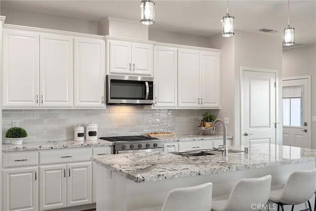 5122 Feather Rock Ct, Paradise, CA 95969 - kitchen featuring appliances with stainless steel finishes, a sink, decorative backsplash, and white cabinets