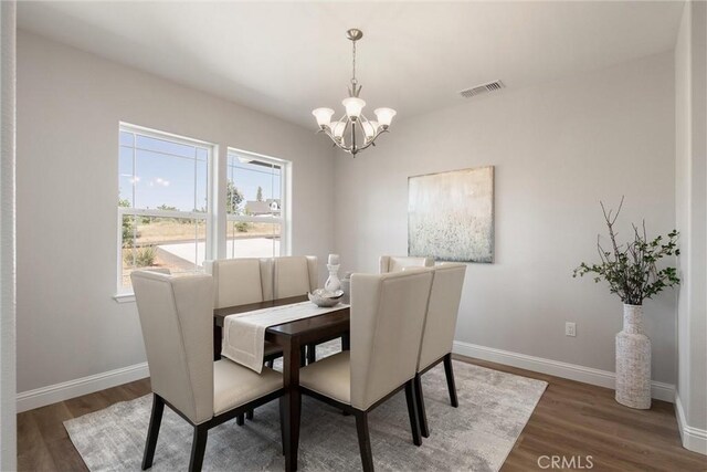 5122 Feather Rock Ct, Paradise, CA 95969 - dining room featuring a chandelier, wood finished floors, and baseboards