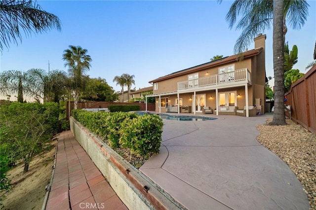 40493 Calle Katerine, Temecula, CA 92591 - back of property featuring a patio, stucco siding, a fenced backyard, a balcony, and a chimney