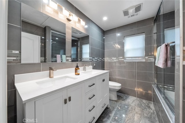 40493 Calle Katerine, Temecula, CA 92591 - bathroom with tile walls, double vanity, toilet, marble tiled flooring, and tiled shower / bath