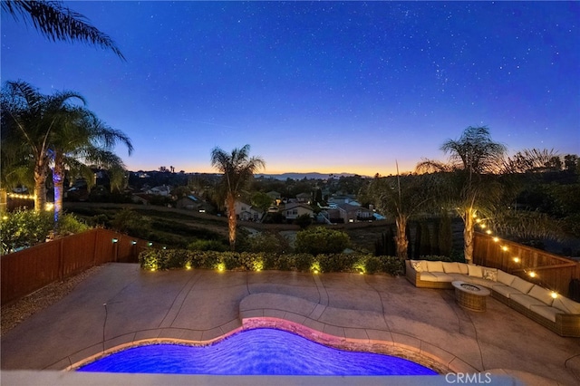 40493 Calle Katerine, Temecula, CA 92591 - pool at dusk with a fire pit, a patio area, and a fenced backyard