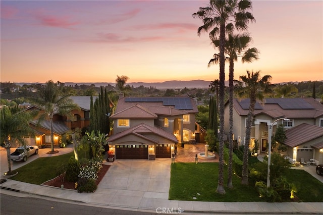 40493 Calle Katerine, Temecula, CA 92591 - mediterranean / spanish house with driveway, roof mounted solar panels, a lawn, an attached garage, and a tile roof