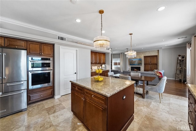 40493 Calle Katerine, Temecula, CA 92591 - kitchen featuring appliances with stainless steel finishes, a chandelier, ornamental molding, recessed lighting, and light stone countertops